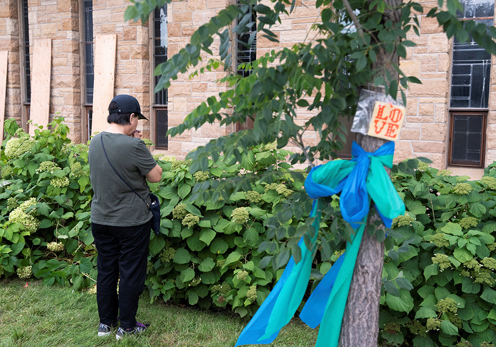 A woman prays outside Annunciation Catholic Church in Minneapolis Sept. 2, 2025, following the shooting Aug. 27. (OSV News/Reuters/Tim Evans)