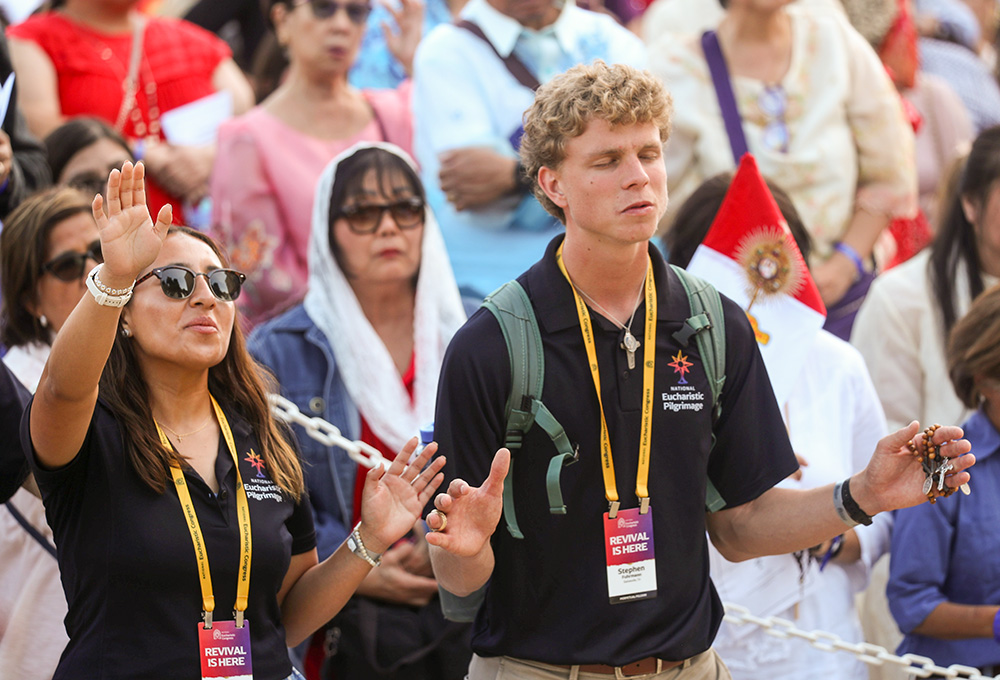 Young people pray near a monstrance after a Mass for the feast of Corpus Christi at the Cathedral of Our Lady of the Angels in Los Angeles June 22, 2025, during the National Eucharistic Pilgrimage. (OSV News photo/Bob Roller)