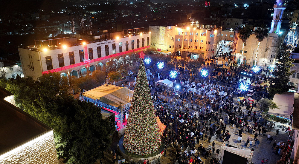 A drone view shows Palestinians attending a Christmas tree lighting in Manger Square outside the Church of the Nativity in Bethlehem in the West Bank Dec. 6, 2025. (OSV News/Reuters/Yosri Aljamal)