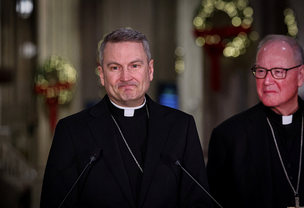 Archbishop Ronald A. Hicks, flanked by New York Cardinal Timothy M. Dolan, pauses while speaking during a news conference at St. Patrick's Cathedral in New York City Dec. 18, 2025, after Pope Leo XIV accepted the resignation of Dolan, and appointed Hicks as his successor. Archbishop Hicks was previously the bishop of Joliet, Illinois. (OSV News/Reuters/Brendan McDermid)