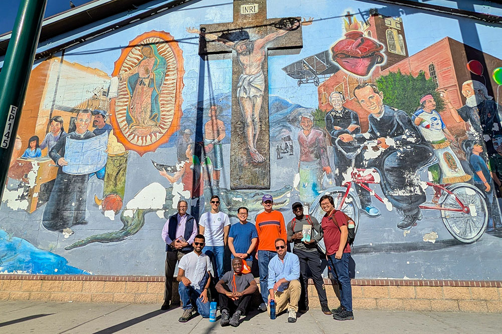 Jesuit seminarians Jaret Ornelas, second from left in back, and Vincent Truong, center in blue, pose with brother Jesuits outside Sacred Heart Church in El Paso, Texas, Dec. 18, 2025. (OSV News/Courtesy of James Holeman)