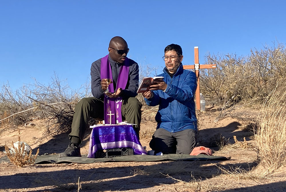 Two unidentified Jesuit priests concelebrate Mass in the Chihuahuan Desert in New Mexico Dec. 21, 2025, for a 20-year-old Guatemalan woman whose remains were previously recovered in the area marked by the cross, and also for two women whose remains were found Dec 19. (OSV News/Courtesy of Collin Price)