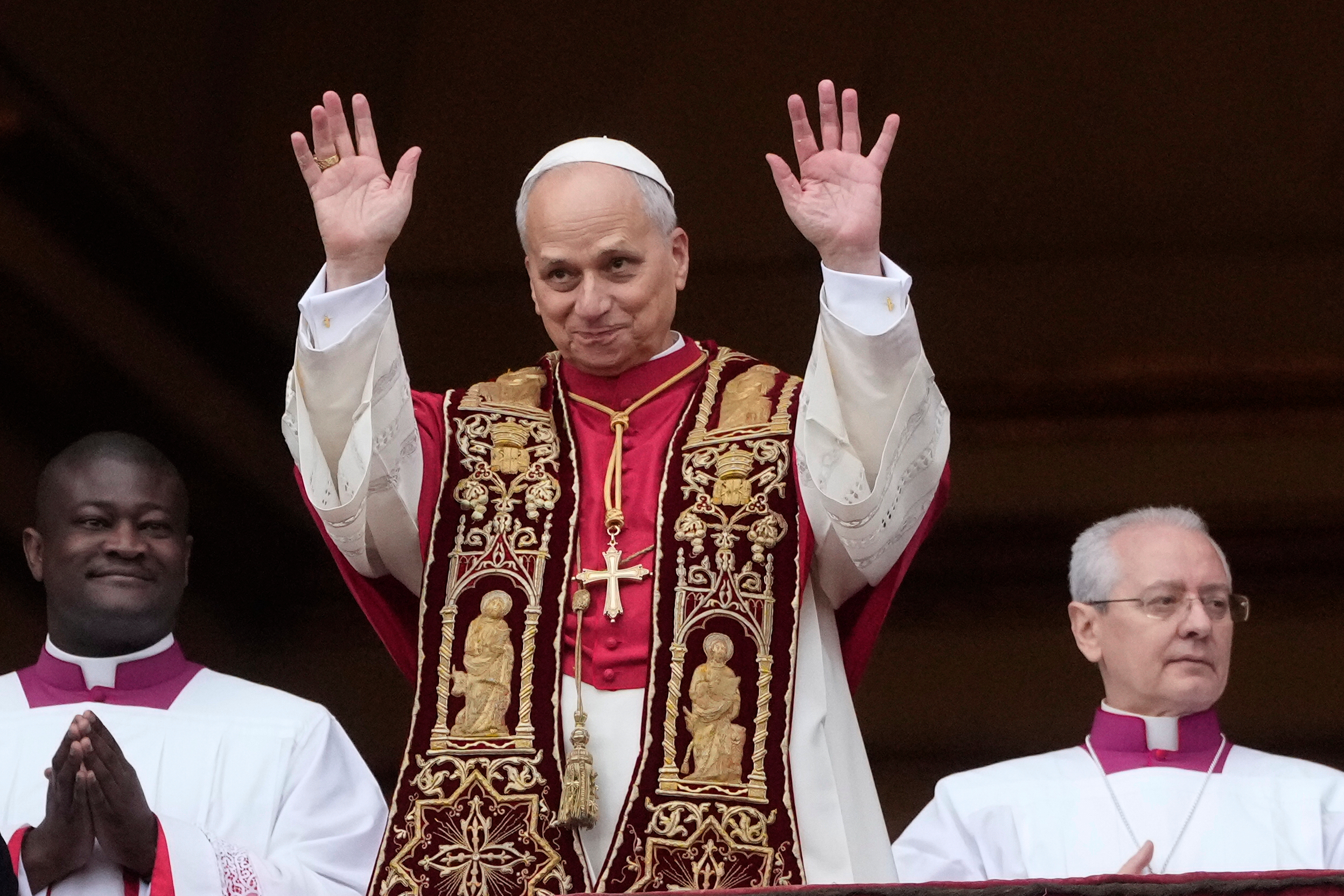 Pope Leo XIV waves after delivering the Urbi et Orbi (Latin for 'to the city and to the world' ) Christmas' day blessing from the main balcony of St. Peter's Basilica at the Vatican, Thursday, Dec. 25, 2025. (AP Photo/Gregorio Borgia)