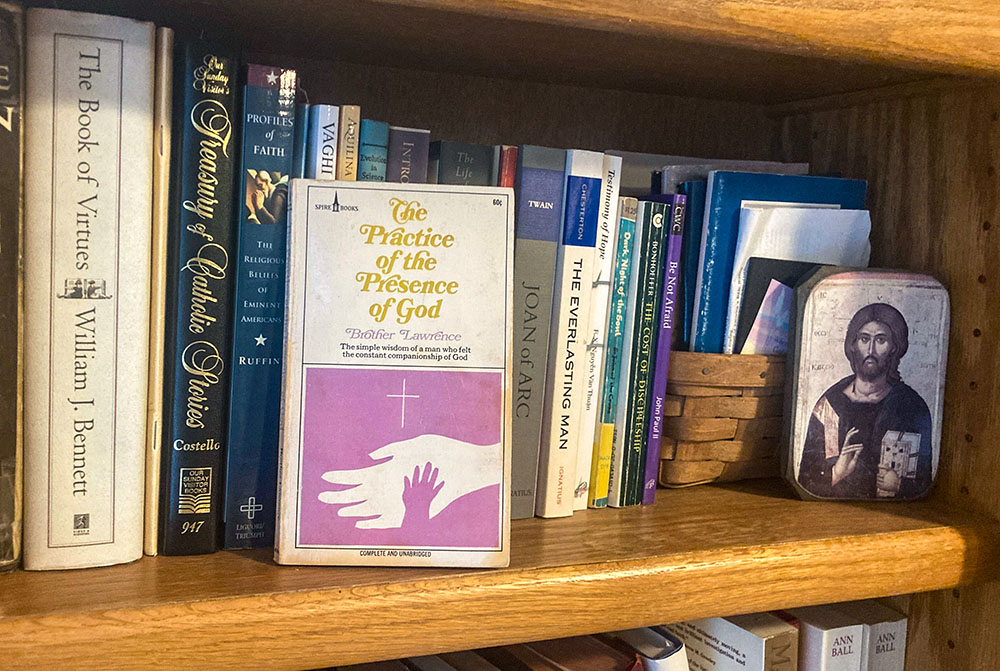 A 1972 edition of Brother Lawrence's The Practice of the Presence of God that belonged to Marge MacLeod sits on a bookshelf in the home of her daughter Carol Zimmermann. (NCR photo/Carol Zimmermann)