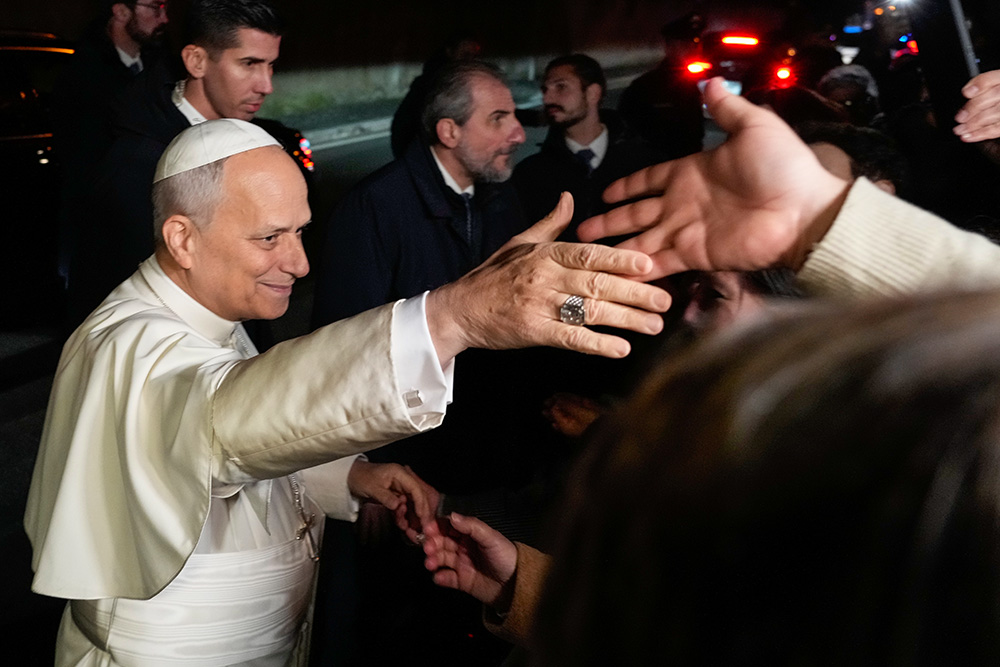 Pope Leo XIV greets people as he leaves the Castel Gandolfo residence in Italy to head to the Vatican Dec. 27, 2025. (AP/Gregorio Borgia)