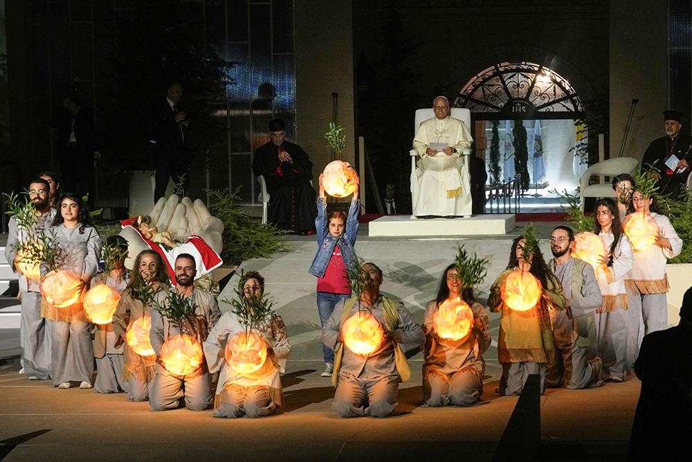Pope Leo XIV watches a performance by youths holding illuminated globes during an event in Bkerki, the seat of the Maronite Church, in Lebanon Dec. 1, 2025. (AP/Domenico Stinellis)