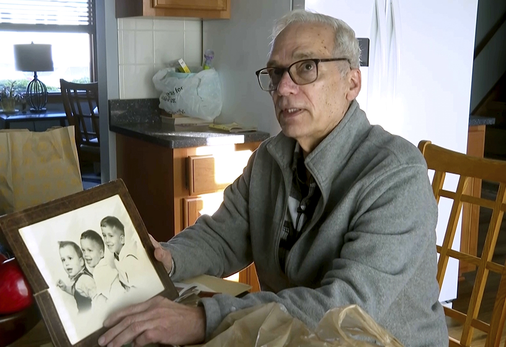 John Prevost, brother of Pope Leo XIV, holds a portrait of the three Prevost brothers from 1958 — Robert (now Leo), 3, left, John, 4, and Louis, 7 — at his home Thursday, May 8, 2025, in New Lenox, Illinois. (AP photo/Obed Lamy)