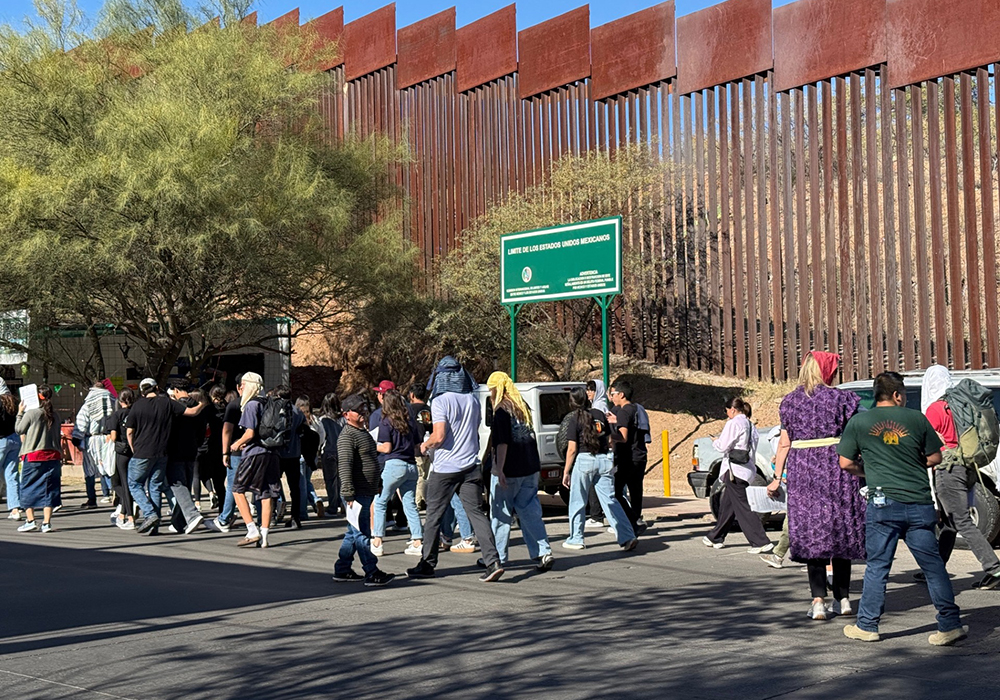 People from Mexico and the United States participate in a traditional posada ("inn" in Spanish) procession along the border between the two countries, Dec. 20 in Nogales, Mexico. (Anita Snow)