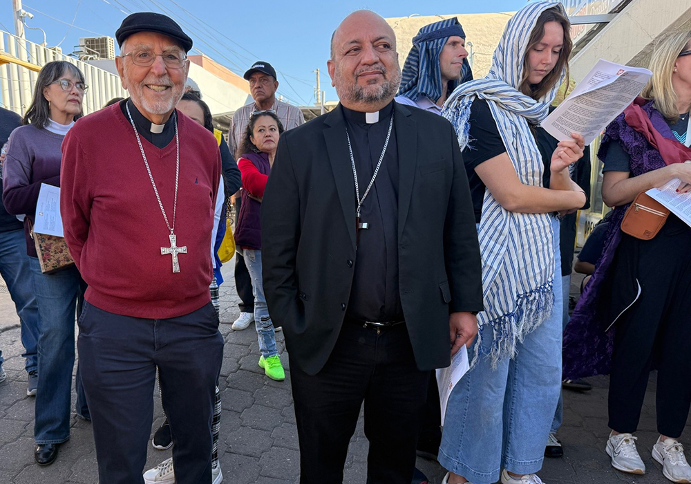 Retired Bishop Gerald F. Kicanas, left, apostolic administrator of the Diocese of Tucson, Arizona, and Bishop José Luis Cerra Luna, right, of Nogales, Mexico, are pictured as the posada along the U.S.-Mexico border wall got underway Dec. 20 in Nogales, Mexico. (Anita Snow)