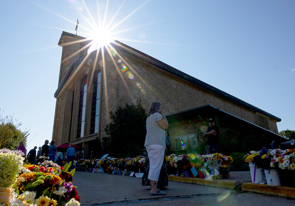 The sun shines over a memorial outside Annunciation Catholic Church during Mass after the Aug. 27 shooting, Sunday, Aug. 31, 2025, in Minneapolis. (AP photo/Ellen Schmidt)