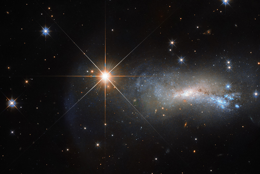 A star named TYC 3203-450-1 outshines a more distant galaxy, NGC 7250, in this Hubble Space Telescope image. (ESA/Hubble & NASA)