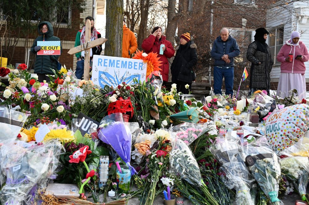 People gather around a makeshift memorial honoring Renee Good, who was fatally shot by an ICE officer, near the site of the shooting in Minneapolis Jan. 9. (RNS/Jack Jenkins)