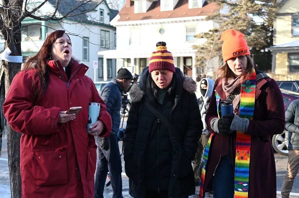 Clergy members sing the hymn "We Rise" at a memorial honoring Renee Good, who was fatally shot Jan. 7 by an ICE officer, near the site of the shooting in Minneapolis Jan. 9. (RNS/Jack Jenkins)
