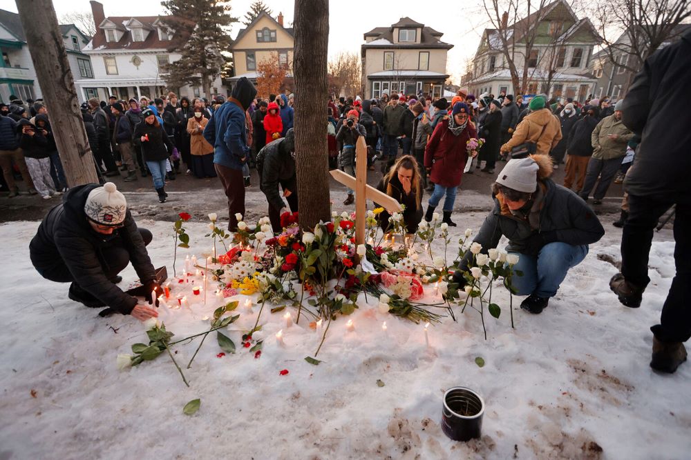 People gather for a vigil after an Immigration and Customs Enforcement officer shot and killed a woman earlier in the day, Jan. 7, in Minneapolis. (AP/Bruce Kluckhohn)