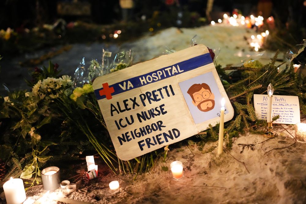 A sign for 37-year-old Alex Pretti, who was fatally shot by a U.S. Border Patrol officer earlier in the day, is displayed during a vigil Jan. 24 in Minneapolis. (AP/Adam Gray)