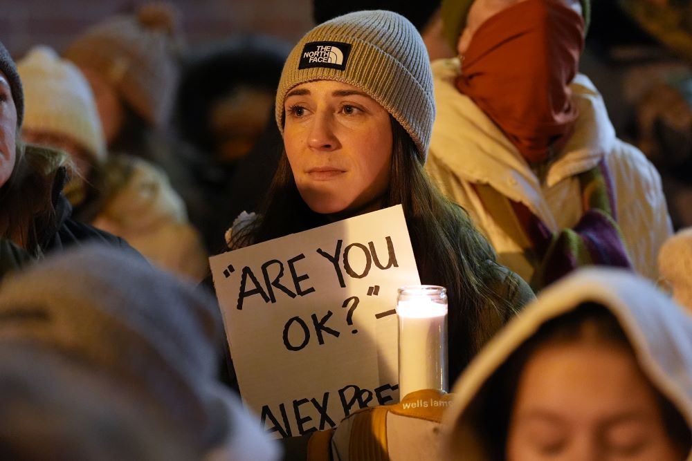 Attendees gather during a vigil where Alex Pretti was shot and killed Jan. 24 by federal officers in Minneapolis on Jan. 28, 2026. Renee Good was shot and killed by ICE agents Jan. 7. (AP/Adam Gray)