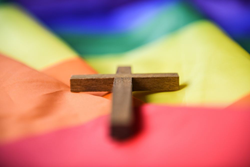 A wooden cross lies on a rainbow flag in Bonn, Germany, March 16, 2021. (OSV News/KNA/Julia Steinbrecht)