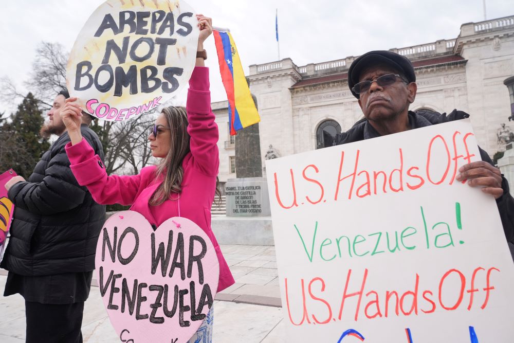 Protesters hold up signs outside the Organization of American States building Jan. 6 at the OAS in Washington. (AP/Jacquelyn Martin)