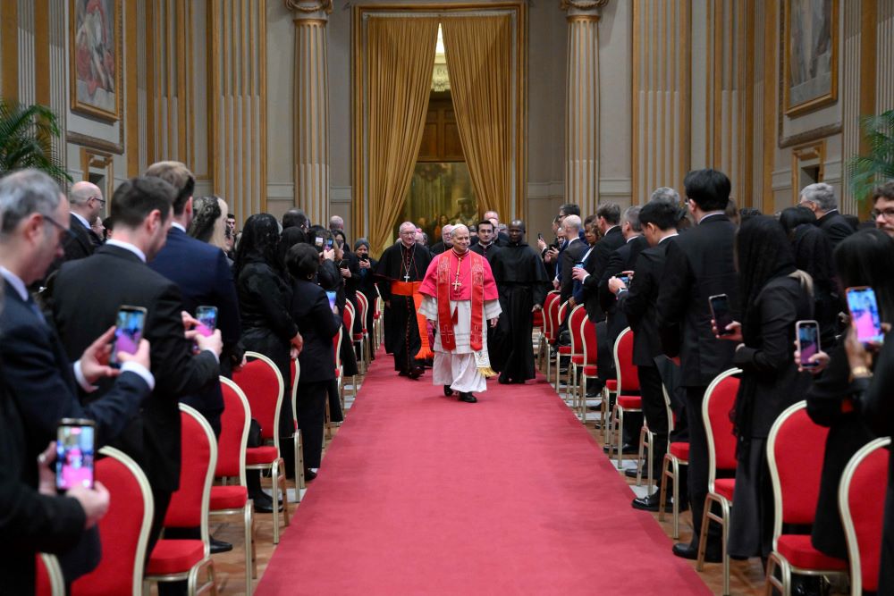 Pope Leo XIV walks down the aisle to meet with members of the diplomatic corps accredited to the Vatican at the Apostolic Palace at the Vatican Jan. 9, 2026. (CNS/Vatican Media)