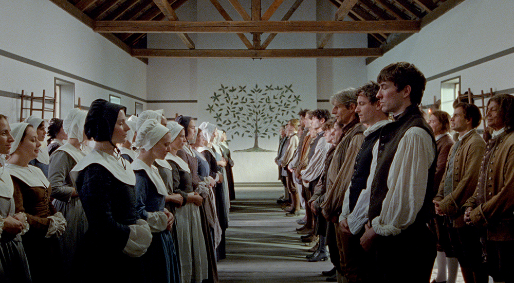 The ensemble is pictured in a still from "The Testament of Ann Lee." Lewis Pullman described the spirituality in "Ann Lee" as both practical and esoteric. (Courtesy of Searchlight Pictures)