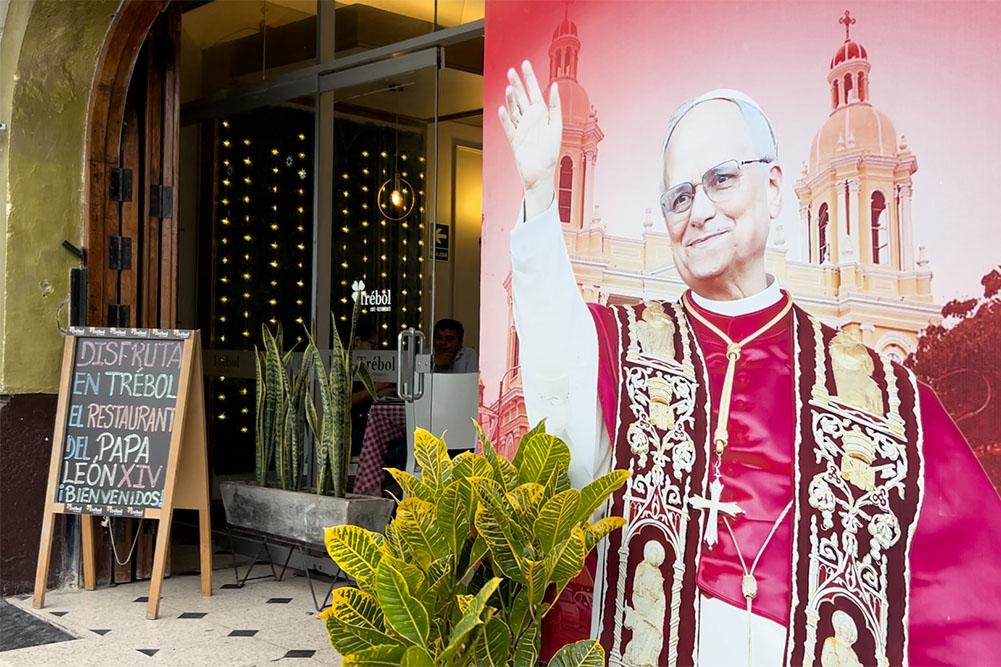 A picture of Pope Leo XIV is seen Aug. 8, 2025, outside a restaurant in Chiclayo, Peru, with a sign saying the pope used to eat there when he was bishop of the Chiclayo Diocese. (NCR photo/Justin McLellan)