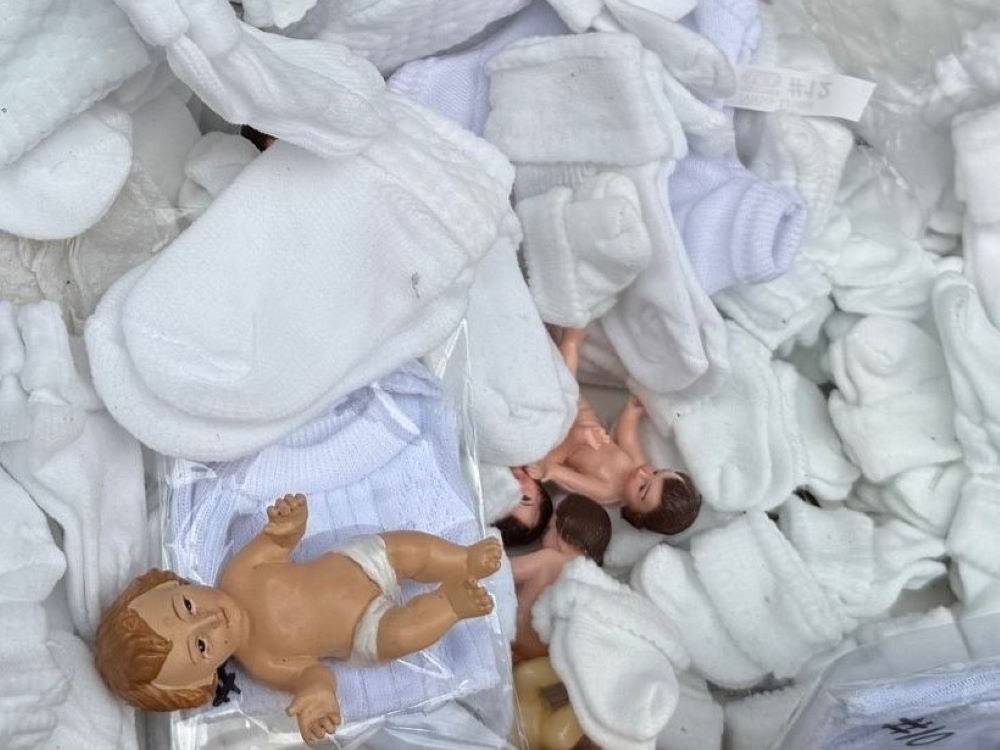 Socks and booties are for sale Jan. 27 at a Mexico City market dedicated to dressing and repairing plaster dolls representing the Christ Child for their presentation at church on Candlemas, Feb. 2. (Anita Snow)