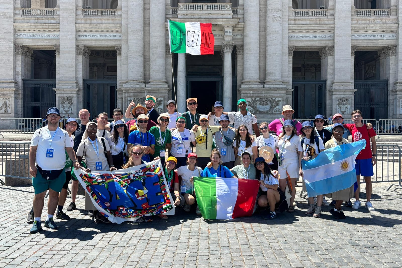 Jeanine Habarugira, Loredana Boniotti, Maite Fernández and Solange Bulangalire, together with a group of young people from the parish of Lumezzane in the Diocese of Brescia, Italy, take part in the Jubilee of Young People as they enter through the Holy Door of the Basilica of St. John Lateran in Rome in August 2025. (Courtesy of Loredana Boniotti)