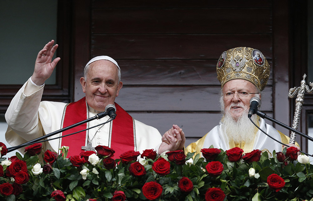 Pope Francis and Ecumenical Patriarch Bartholomew of Constantinople greet a small crowd after delivering a blessing in 2014 in Istanbul. (CNS/Paul Haring)
