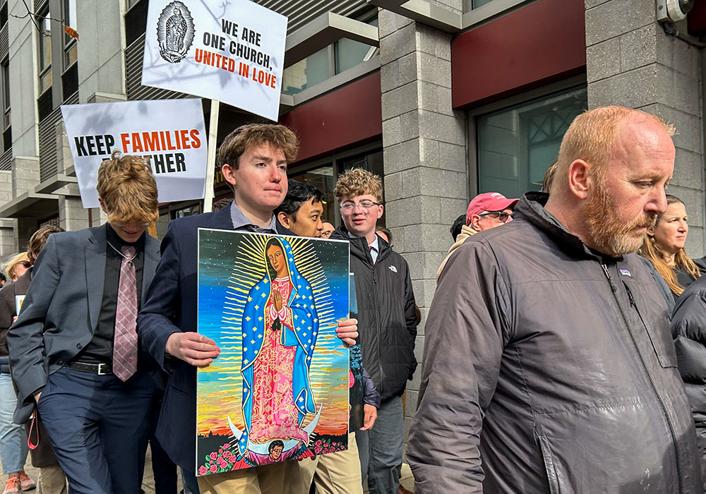A student holds an image of Our Lady of Guadalupe during a Nov. 13, 2025, prayer vigil and eucharistic procession for immigrants outside of the Immigration and Customs Enforcement Office in Philadelphia. The vigil was one of several held across the nation that day as part of the "One Church, One Family" initiative, a grassroots effort launched by several Catholic entities. (OSV News/Gina Christian)