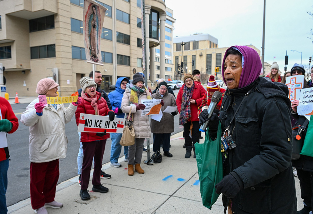 Charlene Howard, executive director of Pax Christi USA, leads community members during a prayer vigil outside the U.S. Immigration and Customs Enforcement headquarters in Washington Dec. 12, 2025. (OSV News/Leslie E. Kossoff)