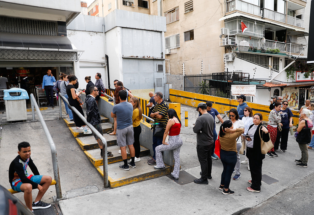 People wait to buy food at a supermarket in Caracas, Venezuela, Jan. 3, 2026, after U.S. President Donald Trump said the U.S. has struck Venezuela and captured its President Nicolas Maduro. (OSV News/Reuters/Leonardo Fernandez Viloria)