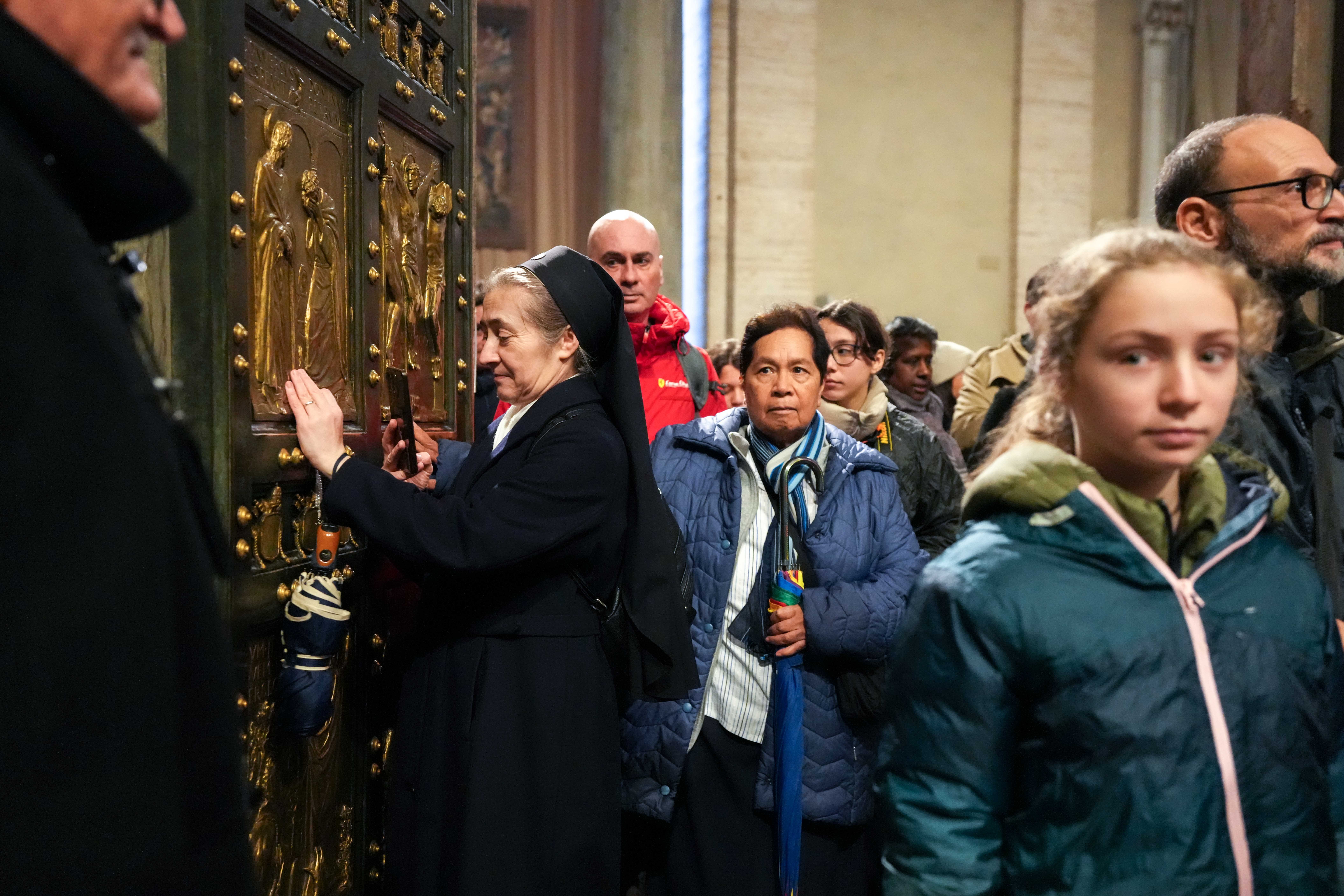 Pilgrims walk through the Holy Door at St. Peter’s Basilica at the Vatican Jan. 5, 2026, the last day it remained open before Pope Leo XIV officially closed it Jan. 6 to mark the end of the Holy Year. (CNS photo/Lola Gomez)