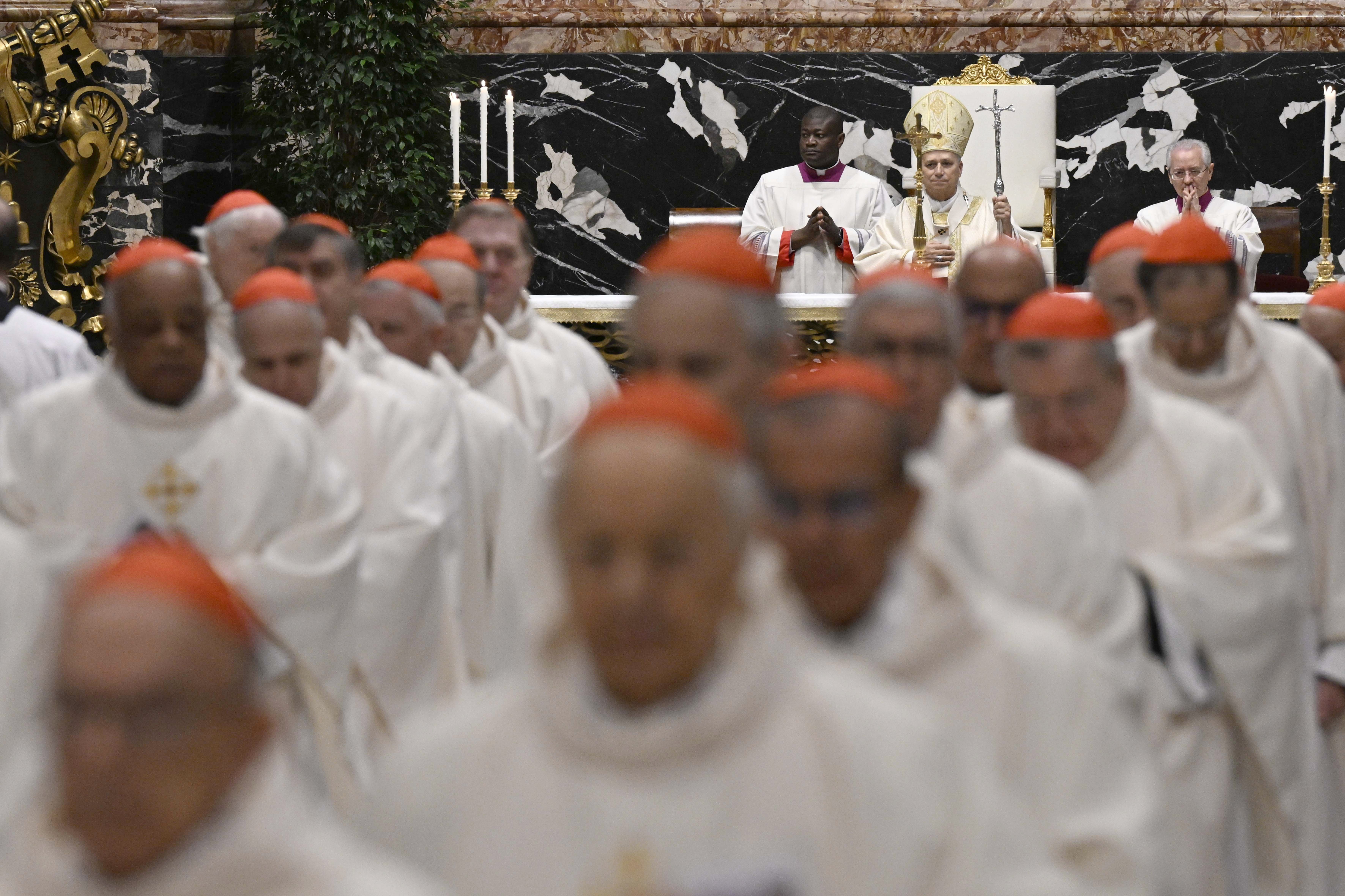 Pope Leo XIV stands with his crosier as cardinals from around the world process out of St. Peter's Basilica at the Vatican Jan. 8, 2026, after the pontiff celebrated an early morning Mass for a consistory. (OSV News/Vatican Media/Simone Risoluti)