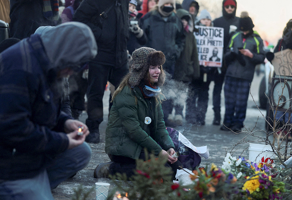 A woman cries next to a makeshift memorial in Minneapolis Jan. 24, 2026, at the site where 37-year-old Alex Pretti was fatally shot earlier that day by a U.S. Border Patrol agent. (OSV News/Reuters/Evelyn Hockstein)