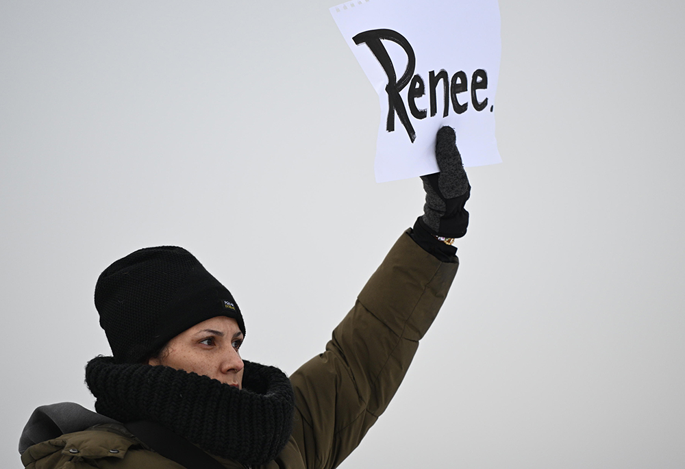 A protester holds up a sign reading "Renee", the woman shot and killed by a U.S. Immigration and Customs Enforcement officer in Minneapolis on Wednesday, outside the Bishop Henry Whipple Federal Building, Thursday, Jan. 8, 2026, in Minneapolis, Minnesota. (AP photo/Tom Baker)