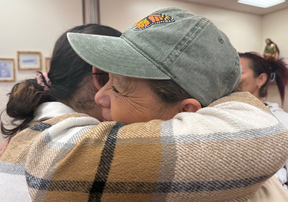 Salvavision founder Dora Rodriguez, right, shares a warm embrace with a member of her board of directors at the conclusion of the celebration organized by the group in Tucson, Arizona, Jan. 4, 2026. (Anita Snow)