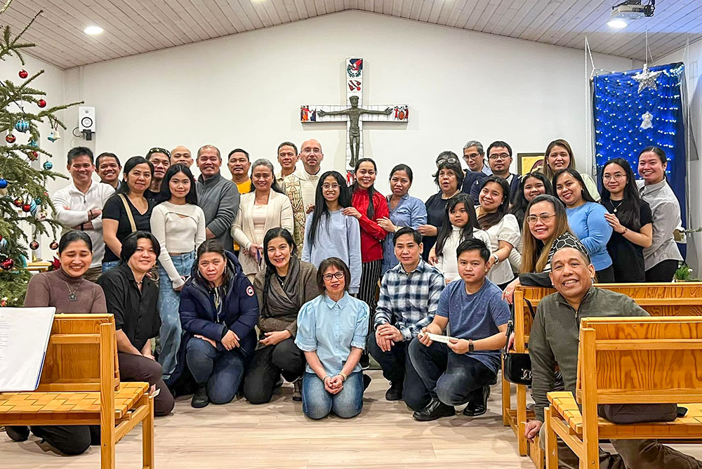 The Catholic community in Nuuk, Greenland, gathers with Franciscan Conventual Fr. Tomaž Majcen, pastor of Christ the King Parish, during Christmas 2024. (Courtesy of Tomaž Majcen)