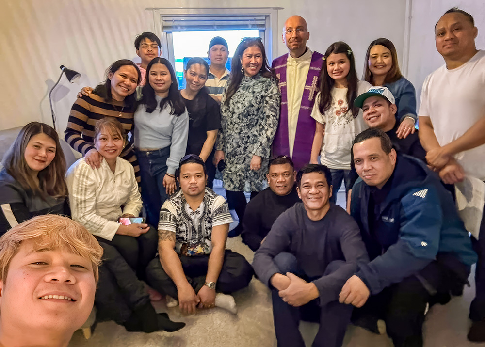 The Catholic community in Ilulissat, Greenland, gathers in a private home for a Mass with Franciscan Conventual Fr. Tomaž Majcen, the only Catholic priest in Greenland, in April 2025. (Courtesy of Tomaž Majcen)
