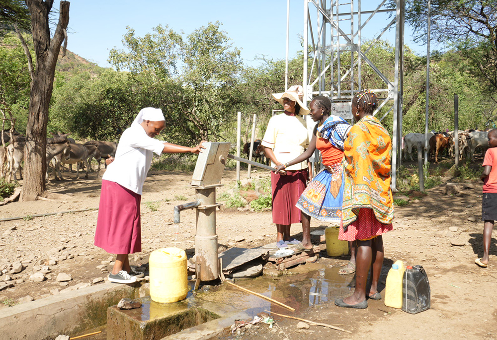 Srs. Aquilina Munyao and Jannifer Hiuhu inspect a borehole the church drilled for Rotu village in northern Kenya. The community protects and maintains the borehole, the only water source for families and their flocks. (GSR photo/Wycliff Peter Oundo)