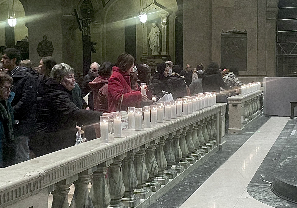 Participants take blessed candles at the end of Mass at the Basilica of St. Mary in Minneapolis, Jan. 25, 2026. (Tim Montgomery)