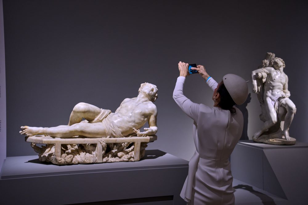 A journalist photographs San Lorenzo, left, and San Sebastiano, two juvenile marble statues by Italian Baroque master Gian Lorenzo Bernini, during the press preview of the exhibition "Bernini and the Barberini" at Palazzo Barberini in Rome on Feb. 11. (AP/Domenico Stinellis)