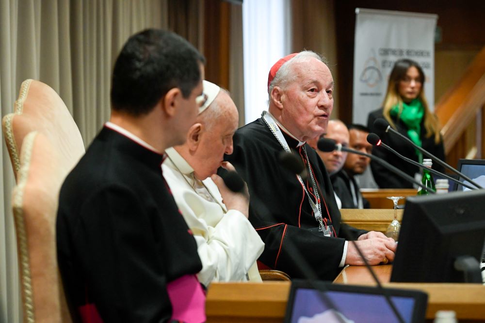 Seated next to Pope Francis, Cardinal Marc Ouellet, president of the Center for Research and Anthropology of Vocations and retired prefect of the Dicastery for Bishops, speaks at an event in the Synod Hall at the Vatican March 1, 2024. (CNS/Vatican Media)