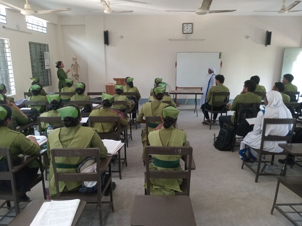 Students at the St. Mary's Catholic Nursing Institute in Toomilia, Bangladesh, listen during a session led by the school's principal, Sr. Mary Dipa. So far, 35 students have graduated and successfully launched professional medical careers. (Sumon Corraya)