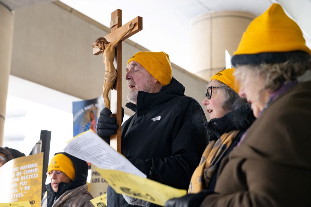 Fr. Dennis Berry, a member of the Missionary Servants of the Most Holy Trinity, holds a crucifix during a news conference outside the Immigration and Customs Enforcement office at the Federal Building in Chicago Dec. 19, 2025. (OSV News/Hailey Hoffman)
