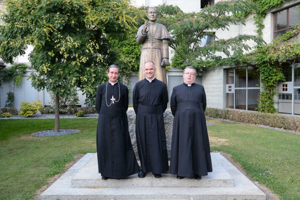 Fr. Davide Pagliarani, center, superior general of the traditionalist Society of St. Pius X is pictured during the society's general chapter in Econe, Switzerland July 12, 2018. With him are  Bishop Alfonso de la Galarreta, left, and Fr. Christian Bouchacourt. (CNS/Courtesy fsspx.news) 