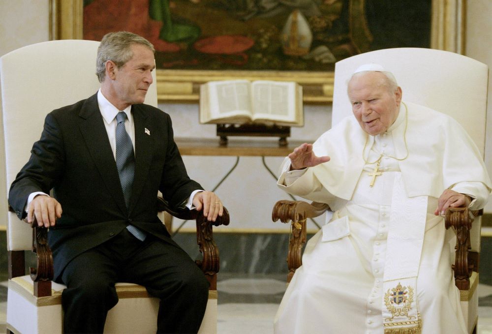 Pope John Paul II talks with U.S. President George W. Bush at the Vatican June 4, 2004, their first meeting after the Iraq war began. The pope, a vocal opponent of the war in Iraq, called for a speedy return to Iraqi sovereignty. (CNS/Reuters)