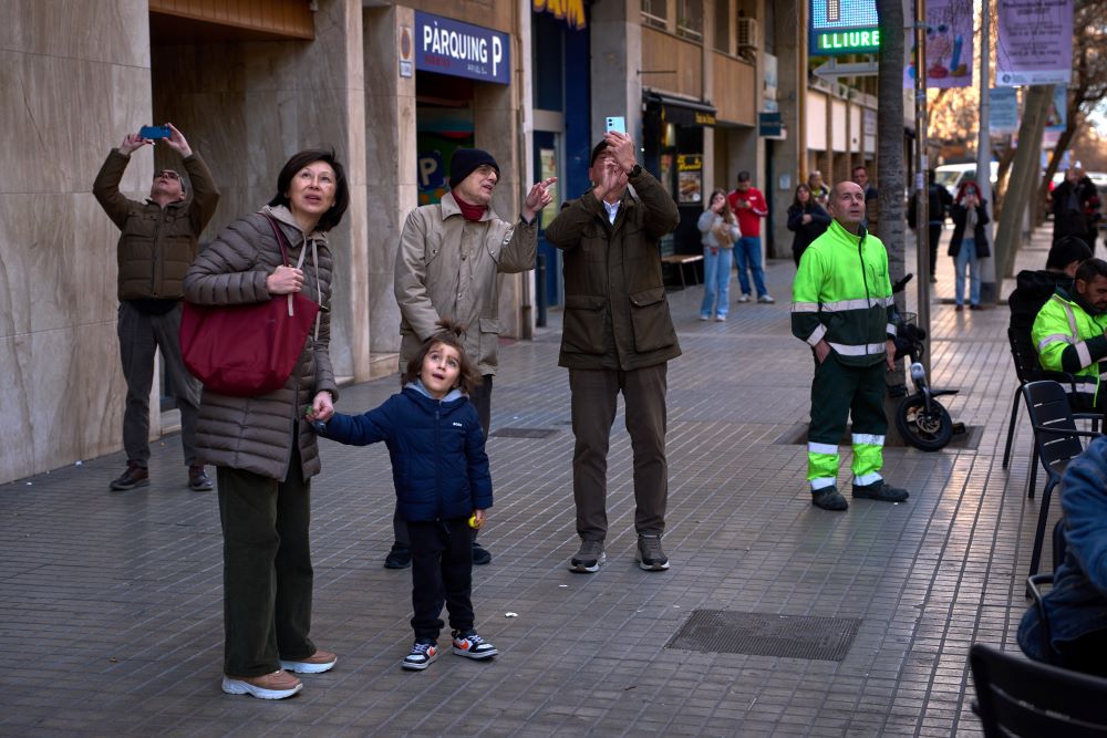 People watch as a crane lifts the upper arm of the cross onto the Tower of Jesus Christ at the Sagrada Familia in Barcelona, Spain, Feb. 20, reaching the basilica's maximum height of 566 feet. (AP/Emilio Morenatti)