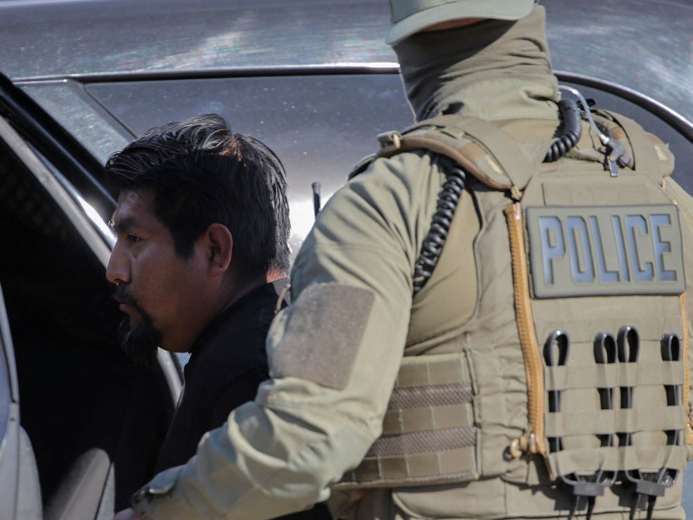 An agent with U.S. Immigration and Customs Enforcement, or ICE, detains a man during an immigration raid in Thermal, Calif., Dec.19, 2025. (OSV News/Reuters/Daniel Cole)