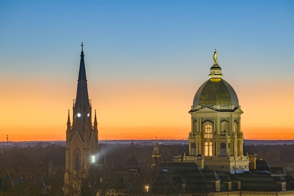 The sun sets over the main building and Basilica of the Sacred Heart steeple on the campus of the University of Notre Dame in South Bend, Ind., Nov. 23, 2025. (OSV News/University of Notre Dame/Matt Cashore)