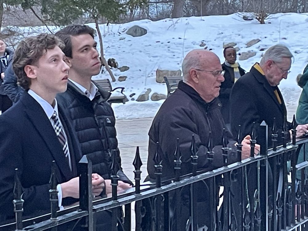 Bishop Kevin Rhoades of Fort Wayne-South Bend, Ind., third from left, prays the rosary with students at the University of Notre Dame at the Grotto of Our Lady of Lourdes Feb. 24, two weeks after calling on the university of Notre Dame to withdraw its appointment of Susan Ostermann as director of the school's Liu Institute for Asia and Asian Studies. (OSV News/Gretchen Crowe)